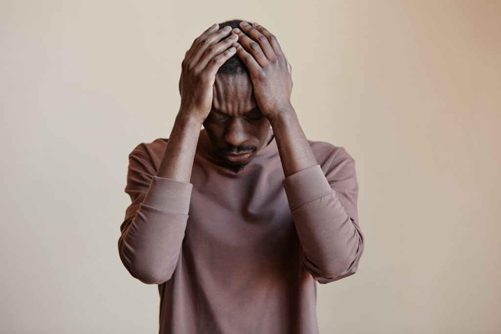 man holding his head in his hands in despair
