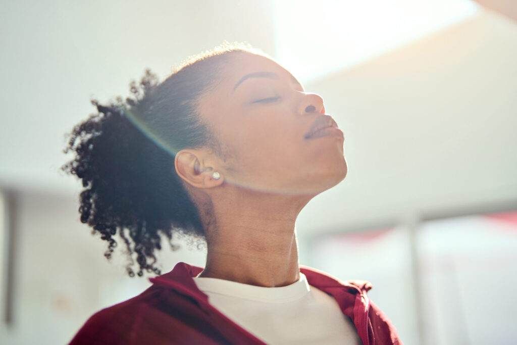 woman looking up with sunlight on her